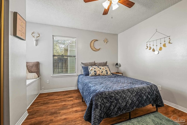 bedroom with ceiling fan, dark hardwood / wood-style floors, and a textured ceiling