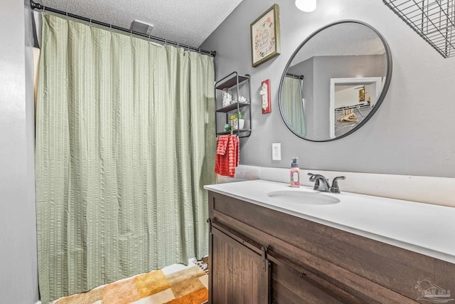 bathroom with vanity and a textured ceiling