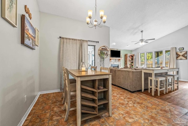 dining area featuring lofted ceiling, ceiling fan with notable chandelier, and a textured ceiling