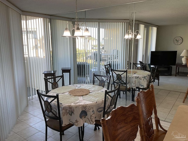 dining area with a notable chandelier, light tile patterned flooring, and a wealth of natural light