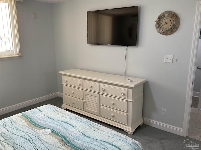 bedroom with dark colored carpet