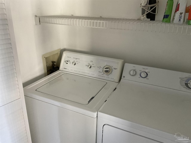 clothes washing area featuring separate washer and dryer