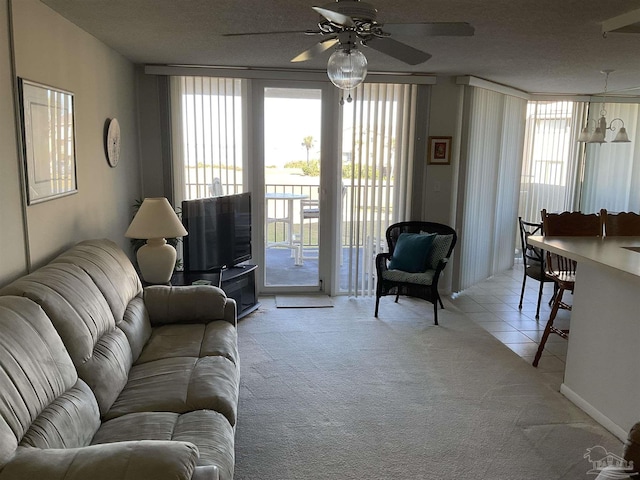 living room with ceiling fan, plenty of natural light, and light carpet