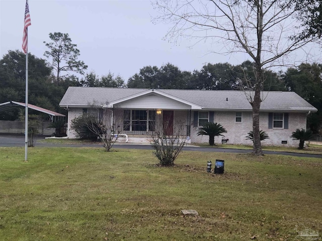 ranch-style home with a front yard, a carport, and covered porch