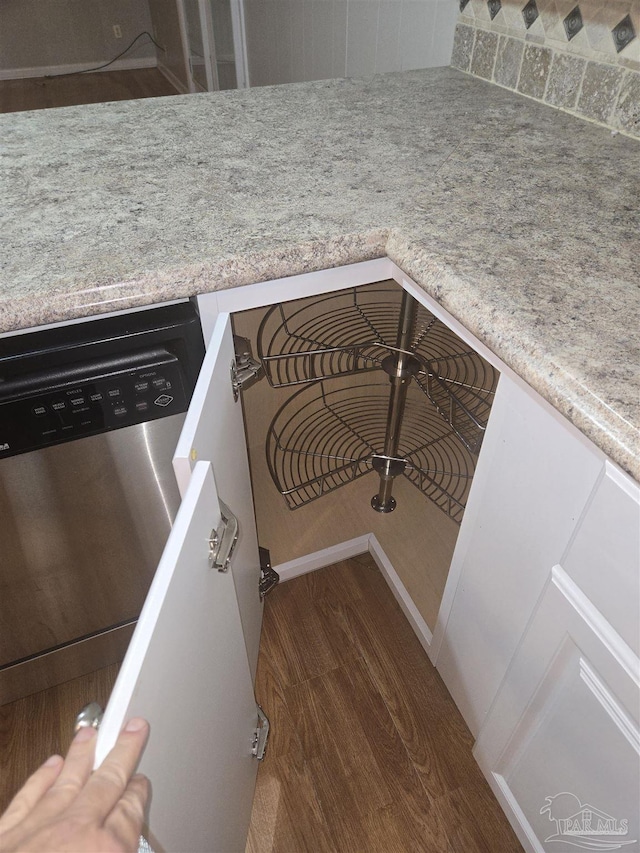 interior details featuring dishwasher and dark hardwood / wood-style flooring