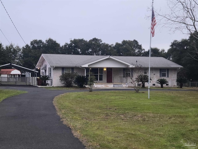 ranch-style house with a front yard, a porch, and a carport