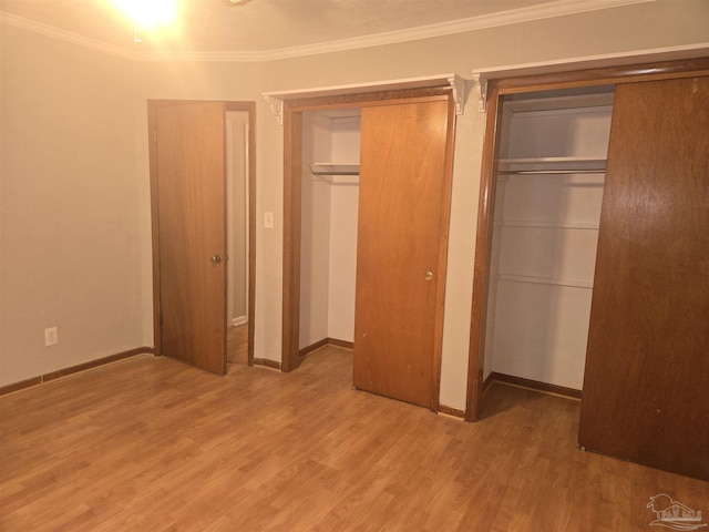 unfurnished bedroom featuring wood-type flooring and ornamental molding