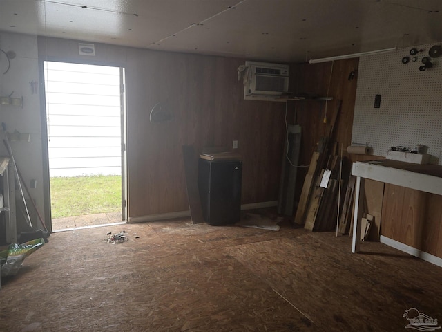 miscellaneous room with a workshop area and an AC wall unit