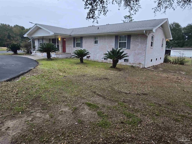 ranch-style home with a porch and a front lawn