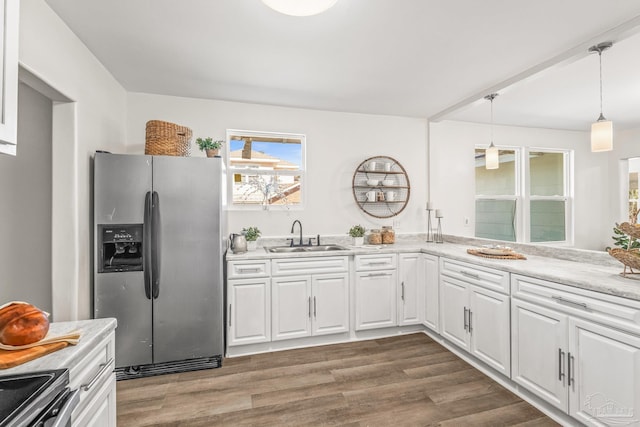 kitchen featuring appliances with stainless steel finishes, dark hardwood / wood-style floors, white cabinetry, and sink