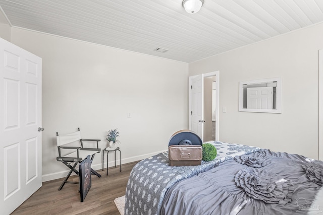 bedroom with dark hardwood / wood-style floors