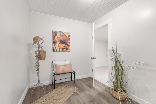 living area with light wood-type flooring, wooden ceiling, and ornamental molding