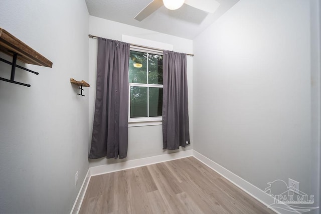 spare room with ceiling fan and light wood-type flooring