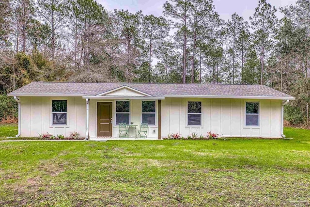 single story home with covered porch and a front yard