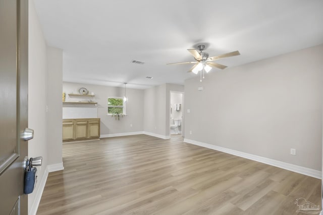 unfurnished living room with ceiling fan and light wood-type flooring