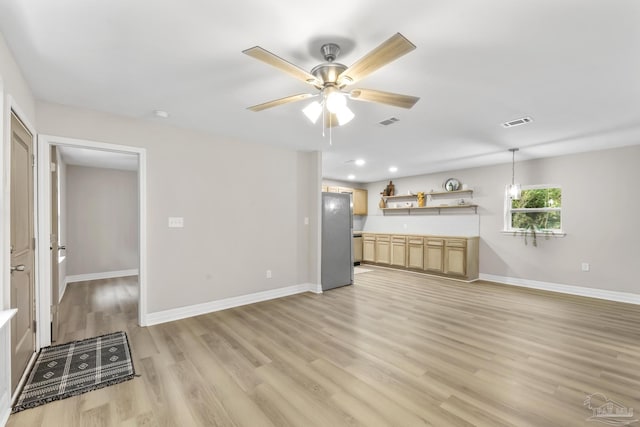 unfurnished living room with ceiling fan and light wood-type flooring