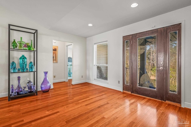 foyer entrance featuring recessed lighting, light wood-type flooring, and baseboards