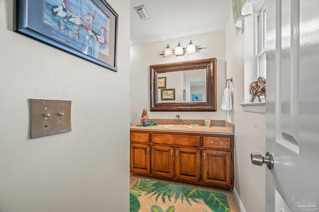 bathroom featuring visible vents, vanity, and tile patterned flooring