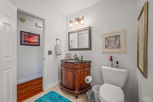 bathroom with vanity, tile patterned floors, toilet, and baseboards