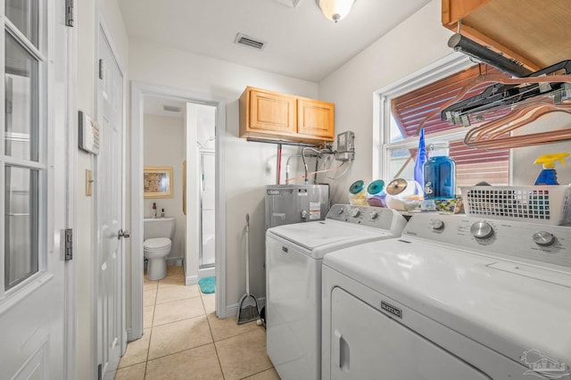 laundry room featuring light tile patterned flooring, visible vents, washer and dryer, and laundry area