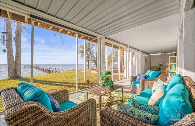 sunroom with a view of the beach and a water view