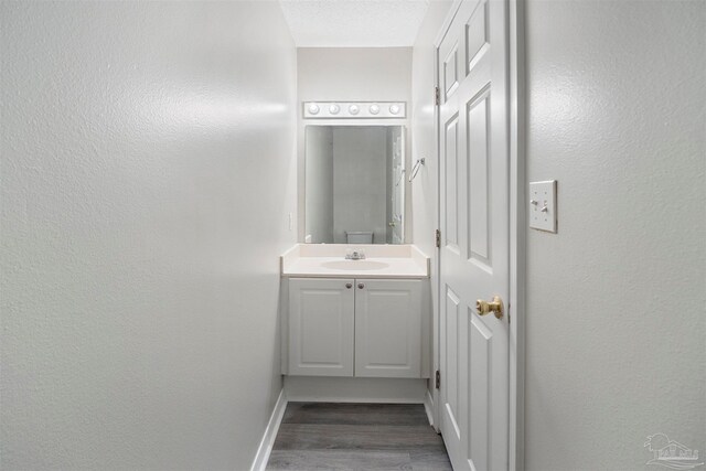 bathroom featuring vanity and hardwood / wood-style flooring