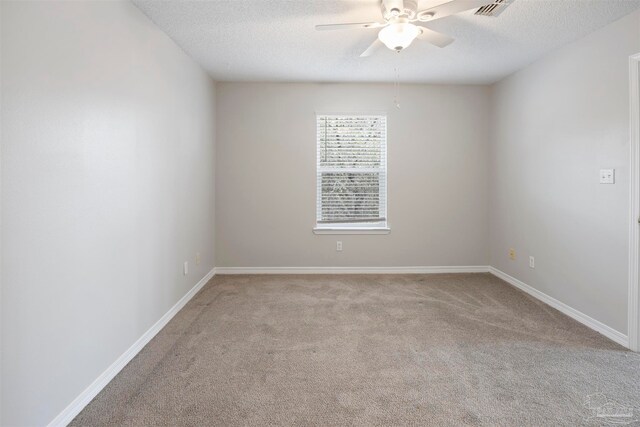 unfurnished room featuring a textured ceiling, ceiling fan, and light carpet