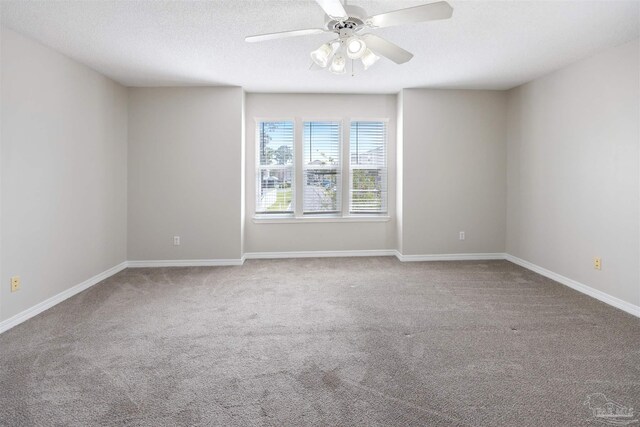 carpeted spare room with ceiling fan and a textured ceiling