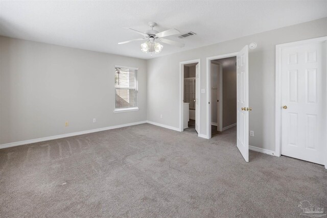 unfurnished bedroom featuring ensuite bath, ceiling fan, and light carpet