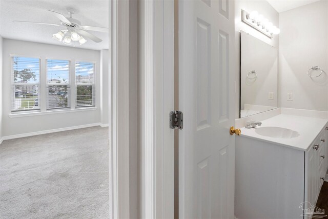 bathroom with ceiling fan and vanity