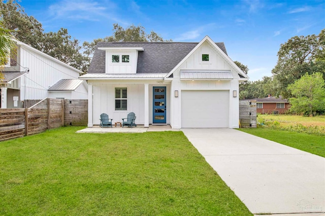 modern inspired farmhouse with a garage and a front lawn