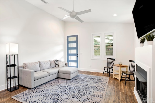 living room featuring hardwood / wood-style floors, ceiling fan, and lofted ceiling