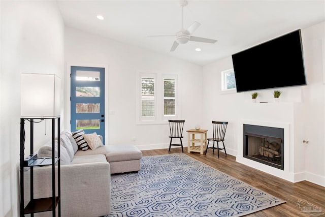 living room featuring ceiling fan, vaulted ceiling, and hardwood / wood-style flooring