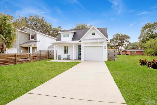 modern farmhouse style home with a front lawn and a garage