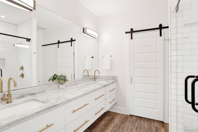 bathroom with vanity, hardwood / wood-style flooring, and a shower with door