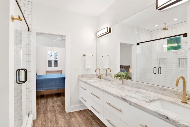 bathroom with hardwood / wood-style floors, plenty of natural light, an enclosed shower, and vanity