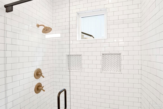 bathroom with a shower with door