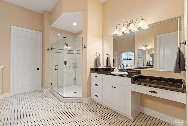 bathroom with a shower with door, tile patterned flooring, and vanity