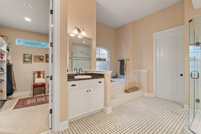 bathroom with vanity, plus walk in shower, and plenty of natural light