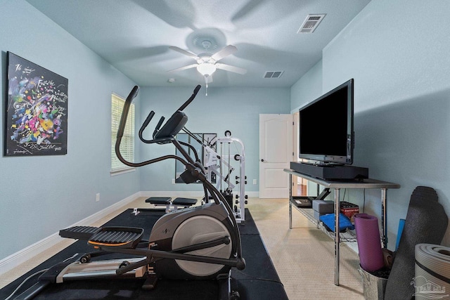 exercise area with light colored carpet and ceiling fan