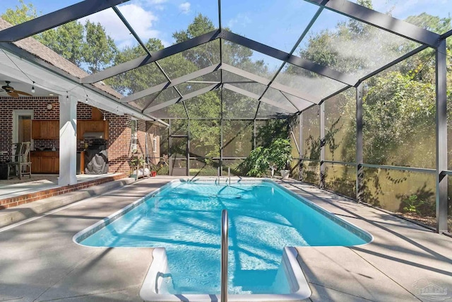 view of swimming pool with a patio area and a lanai