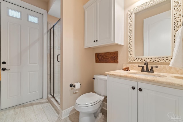 bathroom with vanity, toilet, and walk in shower