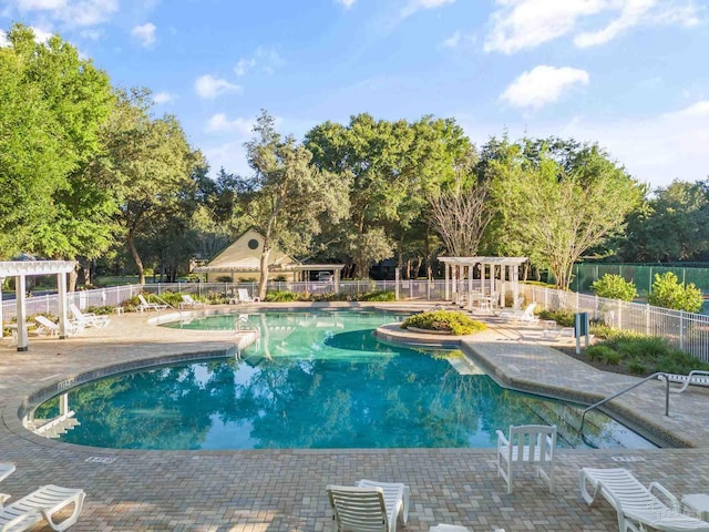 view of pool with a patio and a pergola