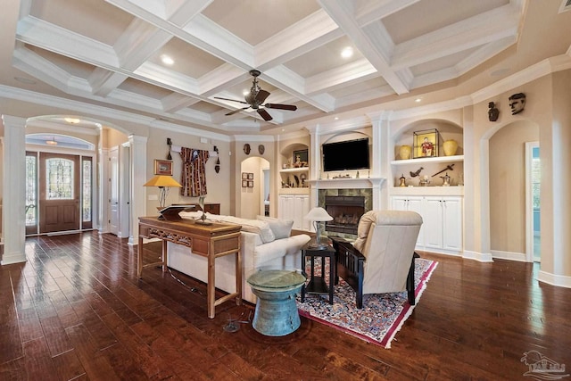 living room with built in shelves, crown molding, coffered ceiling, and dark hardwood / wood-style flooring