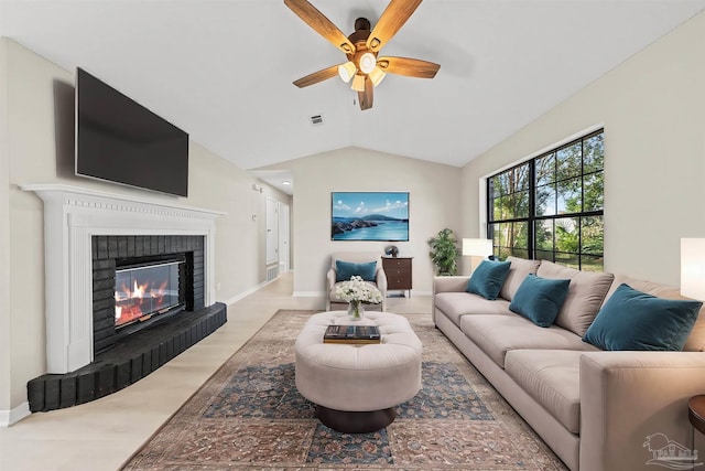 living room featuring a fireplace, light wood-type flooring, vaulted ceiling, and ceiling fan