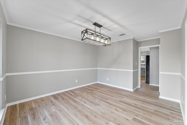 interior space featuring an inviting chandelier, crown molding, and light wood-type flooring