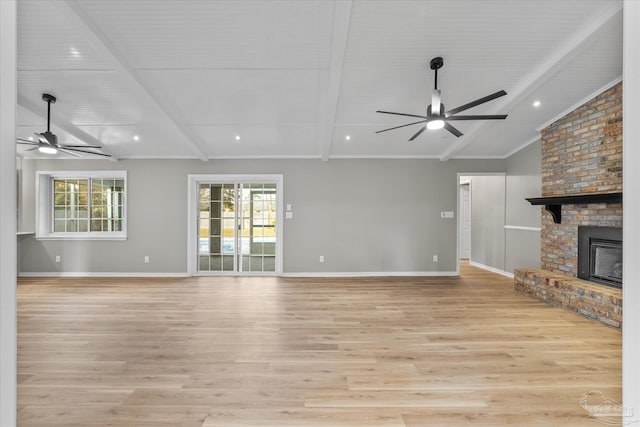 unfurnished living room featuring light hardwood / wood-style floors, a brick fireplace, ceiling fan, and lofted ceiling with beams