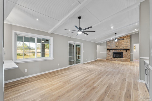 unfurnished living room with a brick fireplace, light hardwood / wood-style flooring, lofted ceiling with beams, and ceiling fan