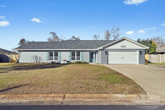 ranch-style house featuring a garage and a front yard