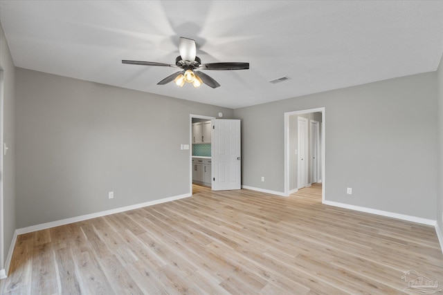 unfurnished bedroom featuring ceiling fan, light hardwood / wood-style flooring, and ensuite bath